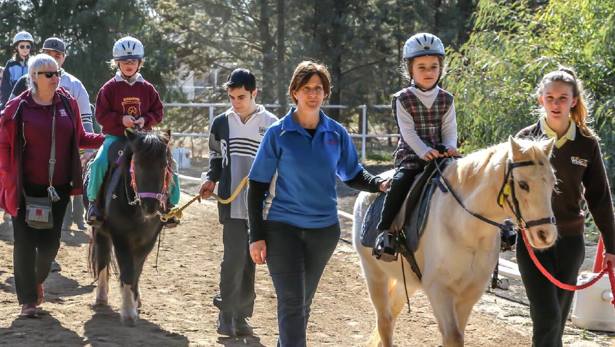 GIDDYUP: Volunteer Jacqui Piccoli (Centre) from Griffith Leeton Riding for the Disabled taking students through a session PHOTO: Griffith Leeton RDA