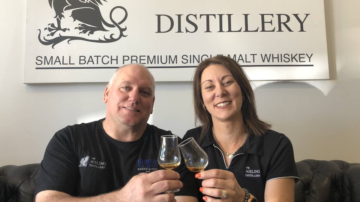SLAINTE: Mark and Michelle Burns share a celebratory drop of their first single malt whiskey after the success of their release Sunday. PHOTO: Kat Vella