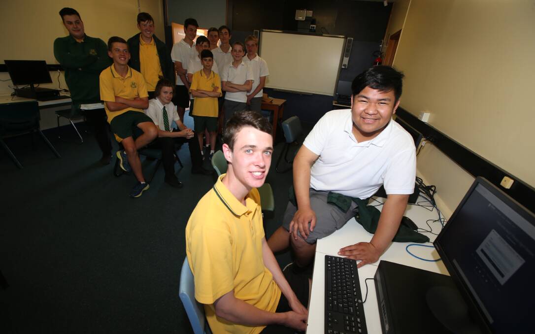 Coding Champs: Year 10 students Jason Truscott and Randy Emmauel Salo got perfect scores in the national coding comp. Picture: Anthony Stipo
