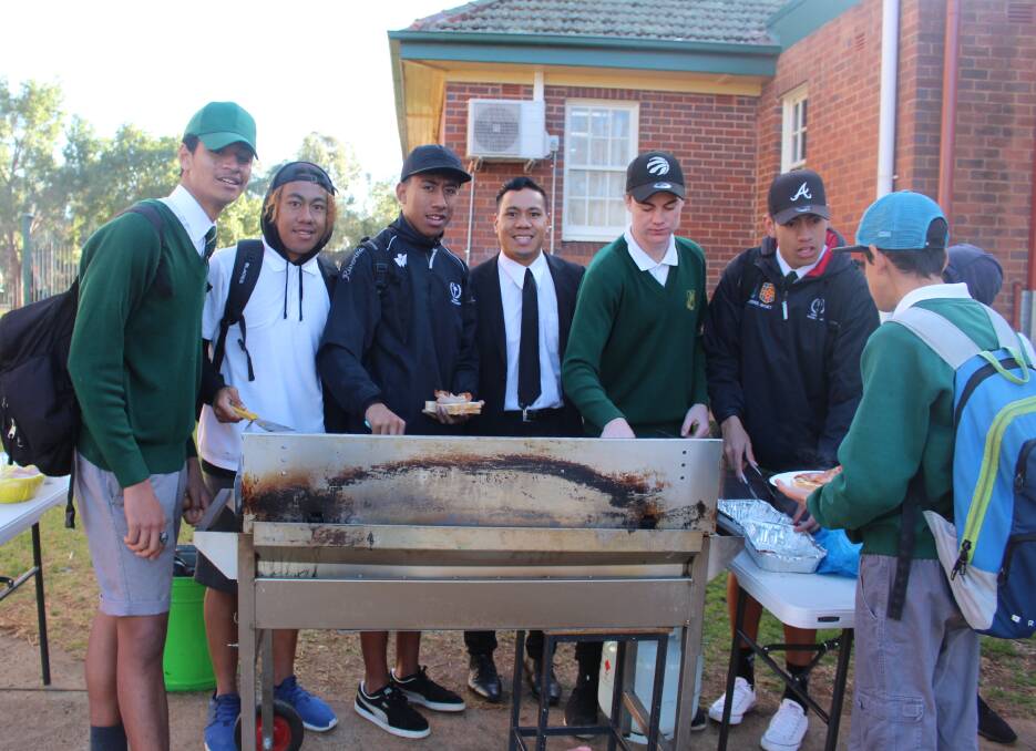 BREAKING BARRIERS: Sam Lemoto, Moses Lolohea, Ofa Lalagauesi, Willie Lolohea, Isaac Campbell and Ngarima Low busy helping out cooking and serving food for Friday's breakfast club. PHOTO: Jacinta Dickins.