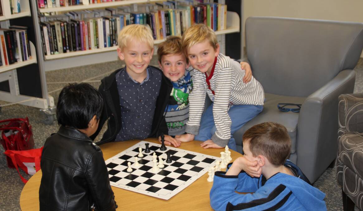 CHEEKY CHESS: These boys are loving the activities held at the Griffith Library, with some very dedicated chess games. PHOTO Jacinta Dickins