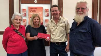 LATEST INSTALLMENT: Back Block Bards authors Joan Vagg, Allan Vagg and Jon Vagg, with the most recent donation of $25,000 for the Dementia Australia Research Foundation, with Bendigo Bank Hillston's Julie Barnett (centre left).