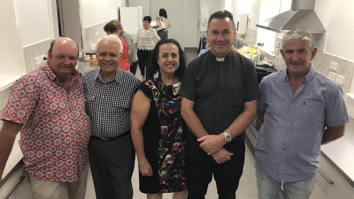 Builder Jim Shannon, builder Angelo Barone, secretary Anna Rosetto, Fr Andrew Grace and plumber Chris Keenan in the new kitchen.