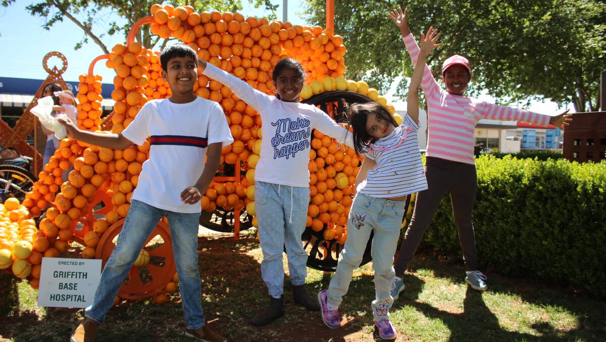 SWING TIME: Akein, Selina, Subanya and Sajali weren't the only ones enthralled with the citrus sculptures lining Banna Avenue on Sunday, a sight heralding the start of Griffith's Spring Fest. PHOTO: Jacinta Dickins