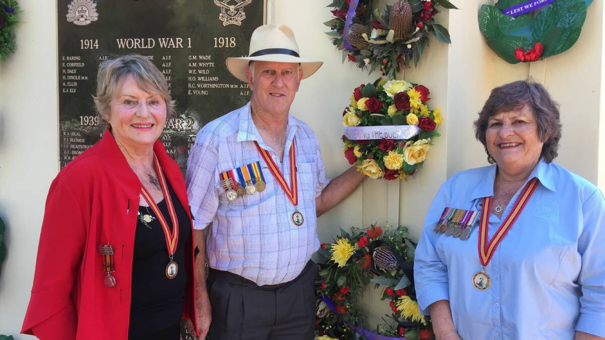 FIRST TIME: Descendants Kay Mitchell, Jeff Dance and Ffiona Beverley wearing commemorative medallions presented to them at the National War Memorial in Canberra. PHOTO: Alison Dance