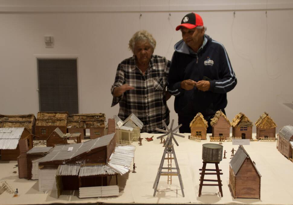 FINAL TOUCHES: Elder Aunty Heather Edwards and Tony Edwards prepare their display for the Exhibition's opening.