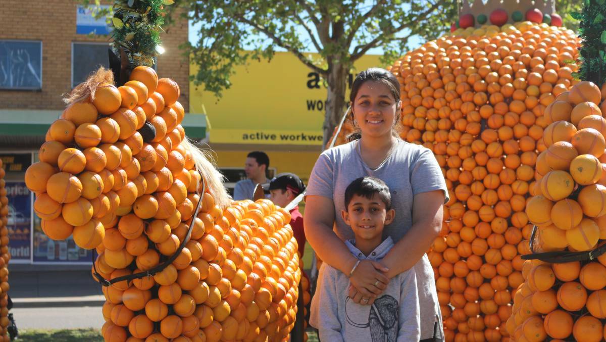 FRUITFUL: Rameek Kaur and Anoop Singh checking out the citrus sculptures at last year's display down Banna Avenue. PHOTO: Jacinta Dickins