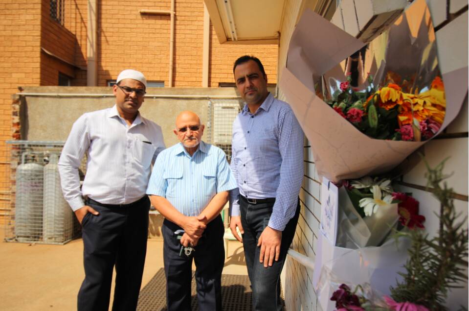 STANDING STRONG: Imran Sayd, Imam Mohammad Mofreh and Zia Khan outside the Griffith mosque, where flowers had been placed near their door in a show of support and grief. PHOTO: Jacinta Dickins