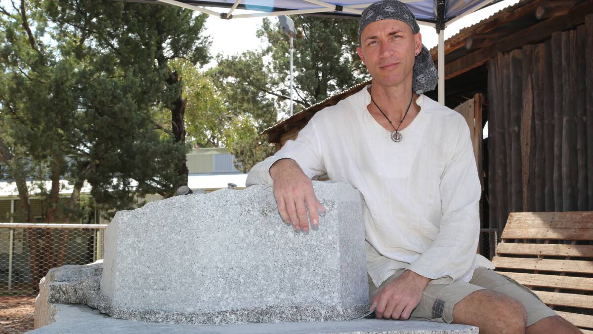 CARVED UP: Artist Luke Zwolsman is currently sculpting a statue to commemorate the 50th anniversary of Griffith's founding. Picture: Anthony Stipo