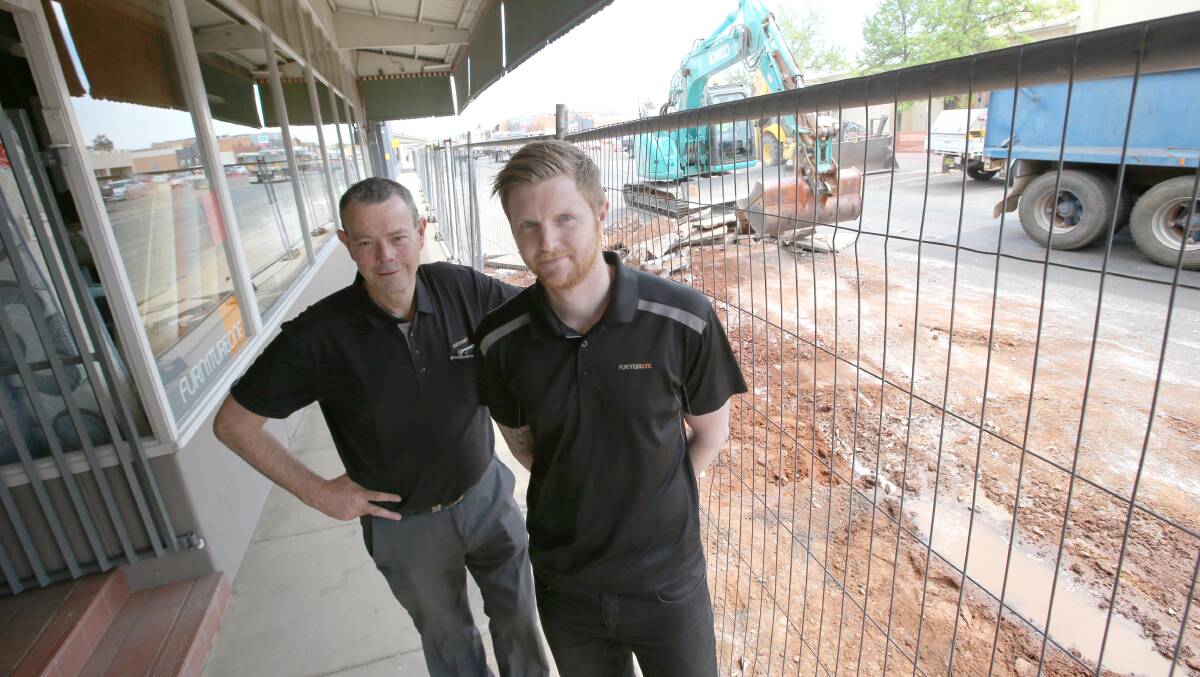 BRING IT ON: Paul Mackay proprietor of Mackay's Furniture One with Ethan Murphy welcome the start of the Yambil street upgrade. Picture: Anthony Stipo