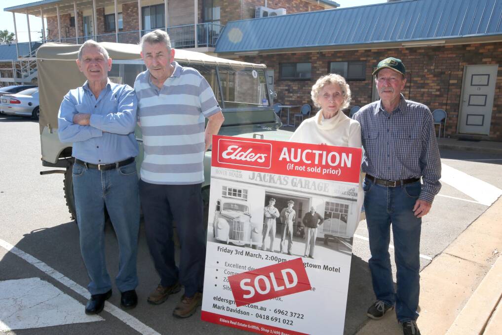 BLAST FROM PAST: Jackas' Garage Mechanics Ken Harris and Ernie Wade (pictured in auction placard as well) with daughter of Jackas' Garage owner Burt Jackas with current Land Rover owner John Higham. Picture: Anthony Stipo