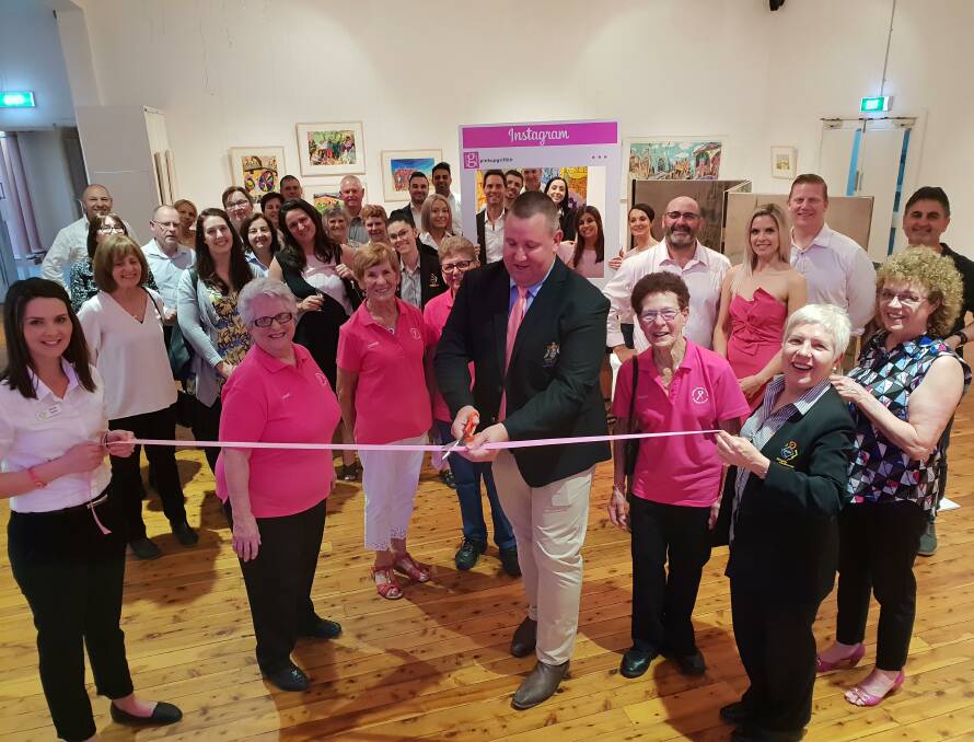 CUT LOOSE: Deputy Mayor Councillor Doug Curran cutting the ribbon to officially mark the start of Pink Up Griffith. Picture: Supplied.