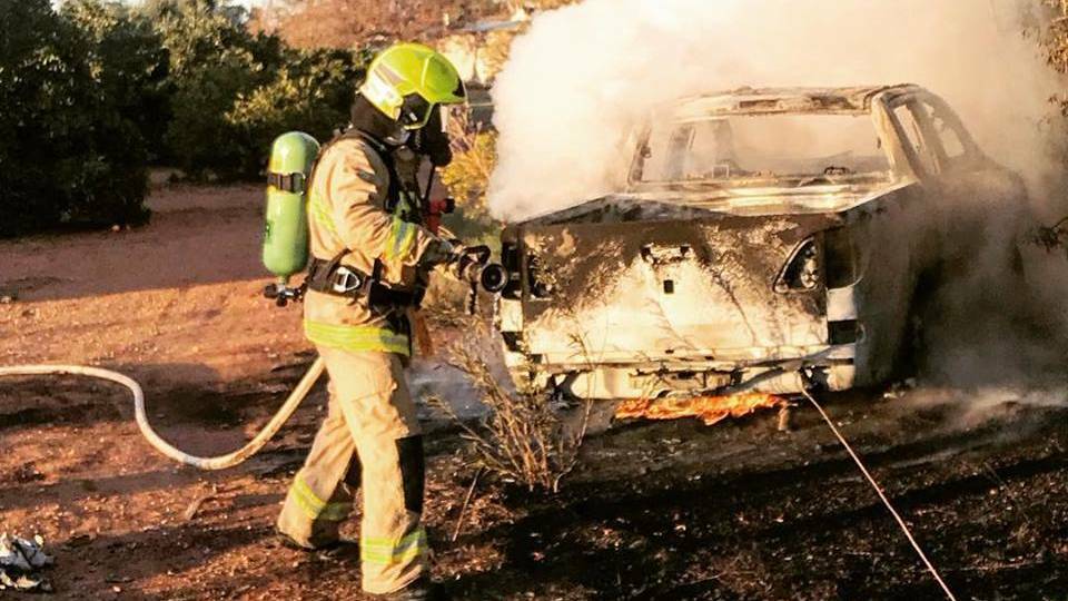 Firefighters work on extinguishing a vehicle fire in Collina on Friday morning. The ute is suspected of being involved in a ram raid nearby shortly before the blaze. Picture: Fire & Rescue NSW Station 311 Griffith