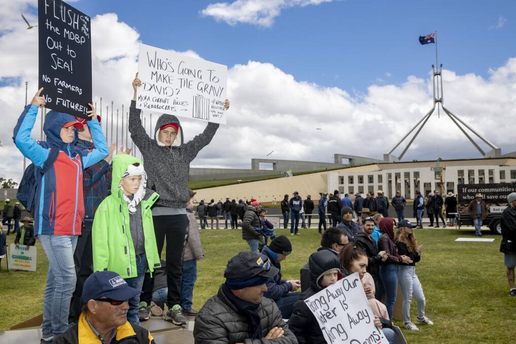 CONVOY: Reuben, 11, and Jude, 7, Haley, and their cousin Jack Villa, 12, from Griffith protest at Parliament House. PHOTO: Sitthixay Ditthavong
