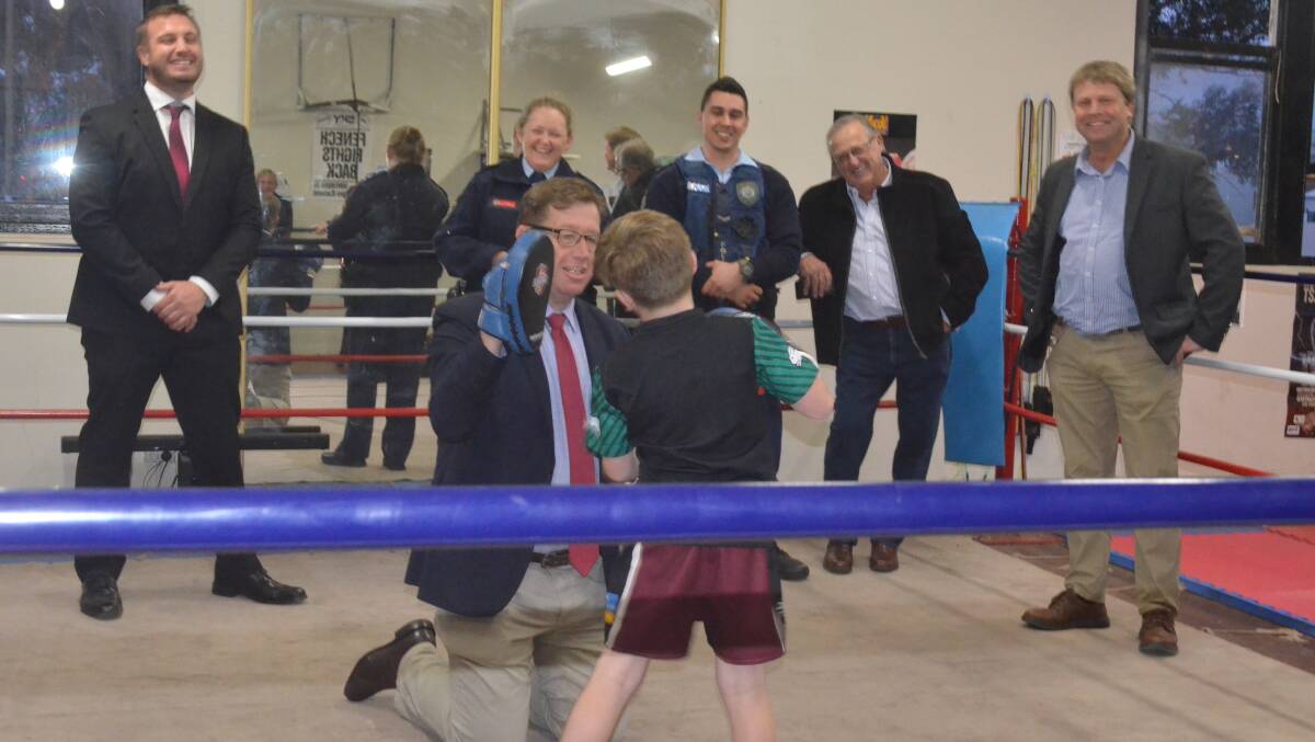 HEAVY HITTER: Young boxer Billy Collis showing MP Grant his moves at Griffith's PCYC . PHOTO: Jacinta Dickins.
