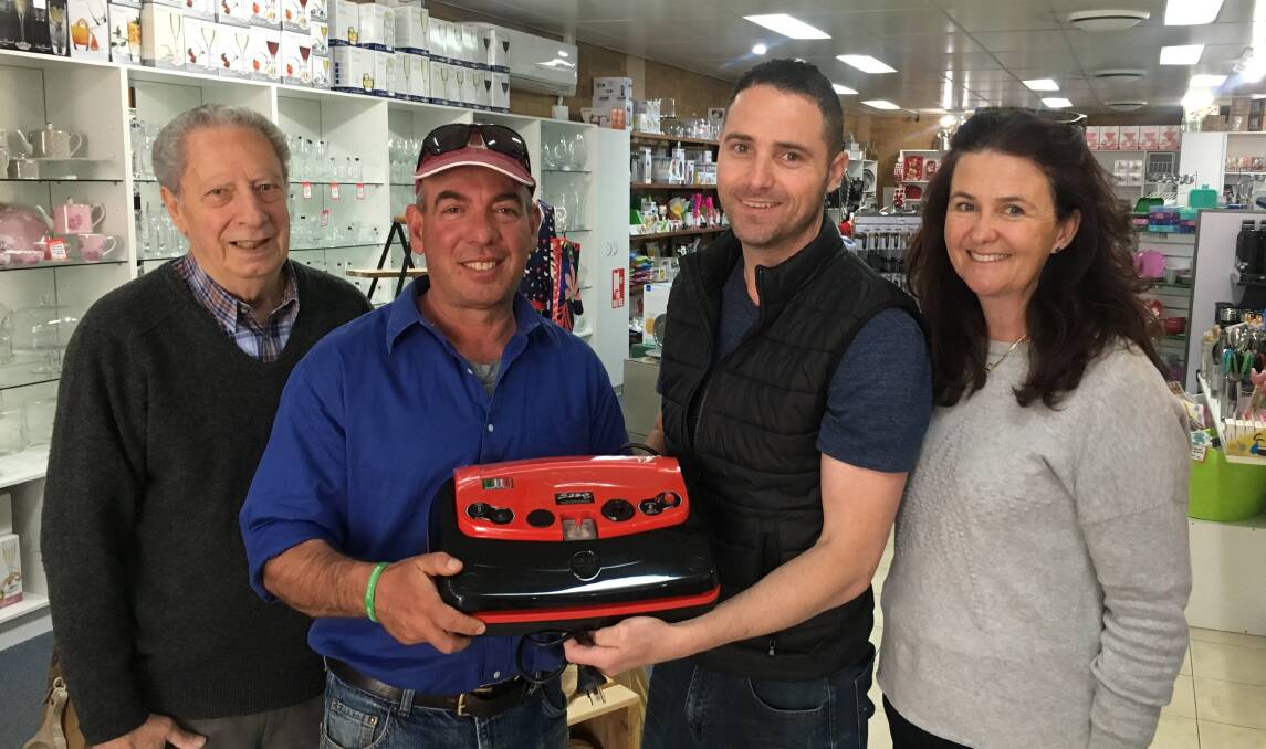 PRIZE: Roy Catanzariti with Nathan from MIA Casa handing the prize for entering a salami into the Griffith Salami Festival to Gino and Jenny Polimeni from Jugiong.