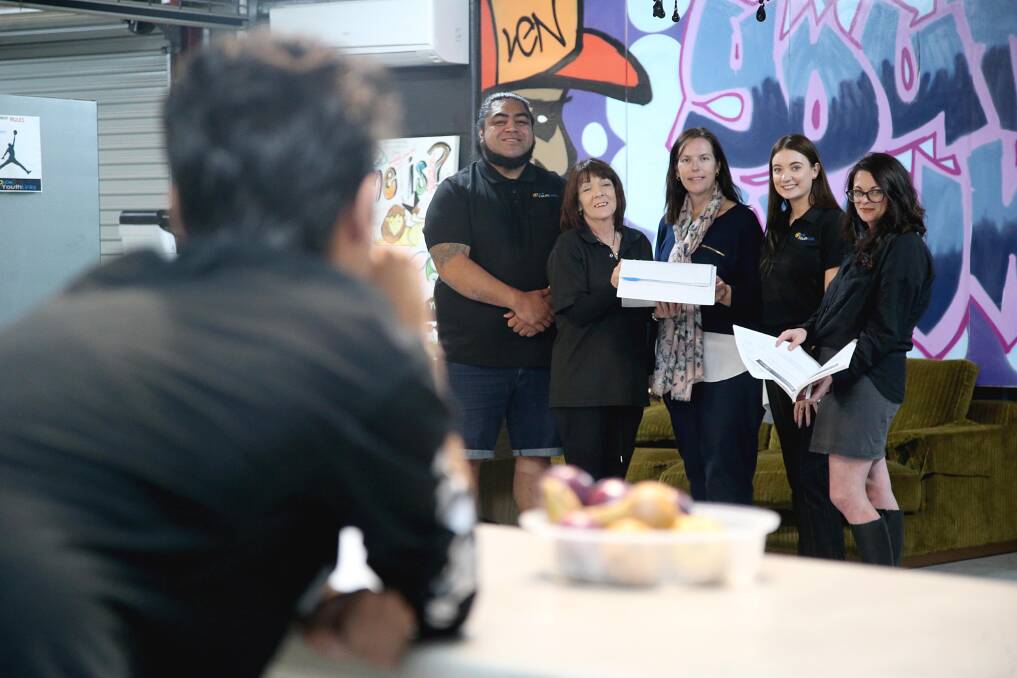 GOVERNMENT ABSENT: Ryan is experiencing the harsh realities of homelessness, yet is helped by Youthlink's Chris Taiao, Cr Deb Longhurst, Kirrilly Salvestro, Stephanie Heath and Fiona Grosser. PHOTO: Anthony Stipo
