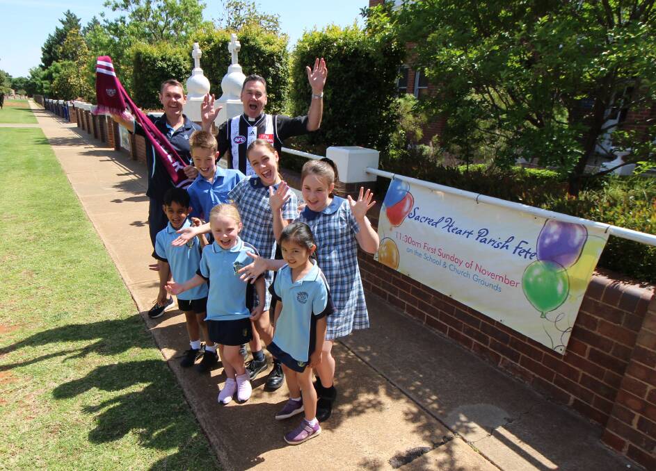 READY: Michael Morrell, Father Andrew Grace along with students from St Patrick's School are getting ready for the annual parish fete on Sunday. PHOTO: Jacinta Dickins
