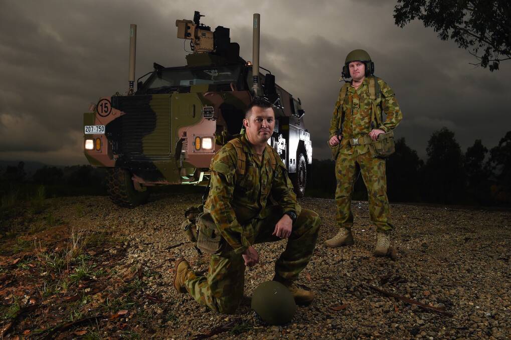 VITAL SERVICE: Australian Army soldiers Corporal Ian Wilson and Warrant Officer Class 2 Cameron McKenzie with the Army Logistic Training Centre's "bushmaster" tank at Bandiana. Picture: MARK JESSER