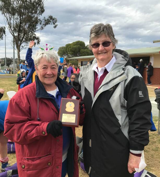 GOING OUT STRONG: In her final year, Janet (left) collected the Ann Paul Memorial Shield after her side’s trip to Parkes for the Half State Masters Hockey Championships.