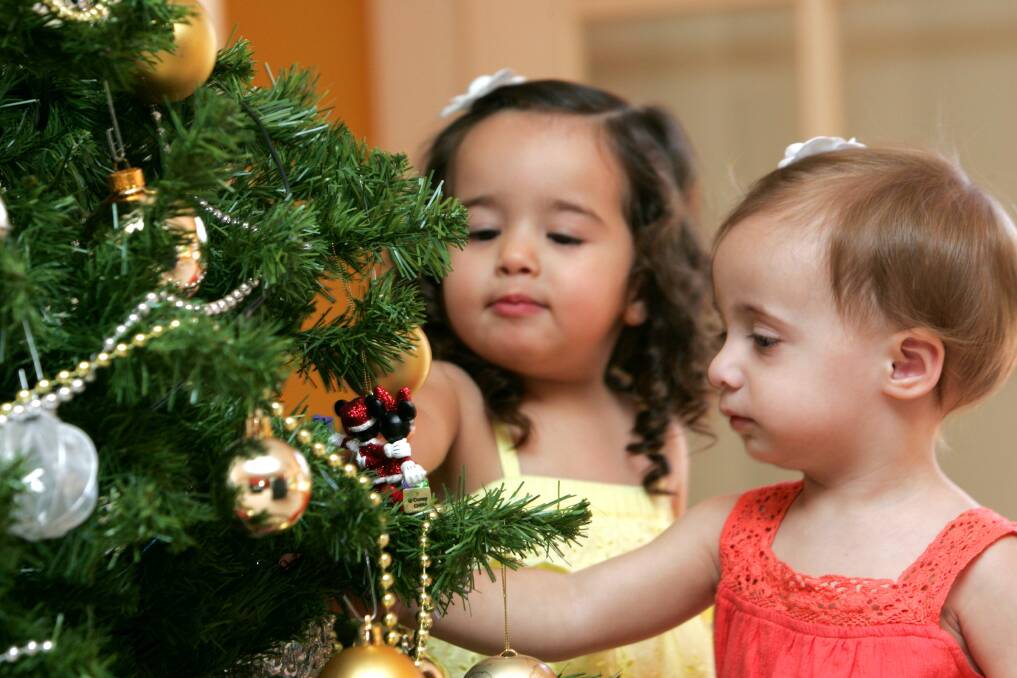 2008: Putting the finishing touches on the Christmas tree in preparation for Thursday’s big day are Maree Sergi, 2, and Mia Restagno, 20 months. 