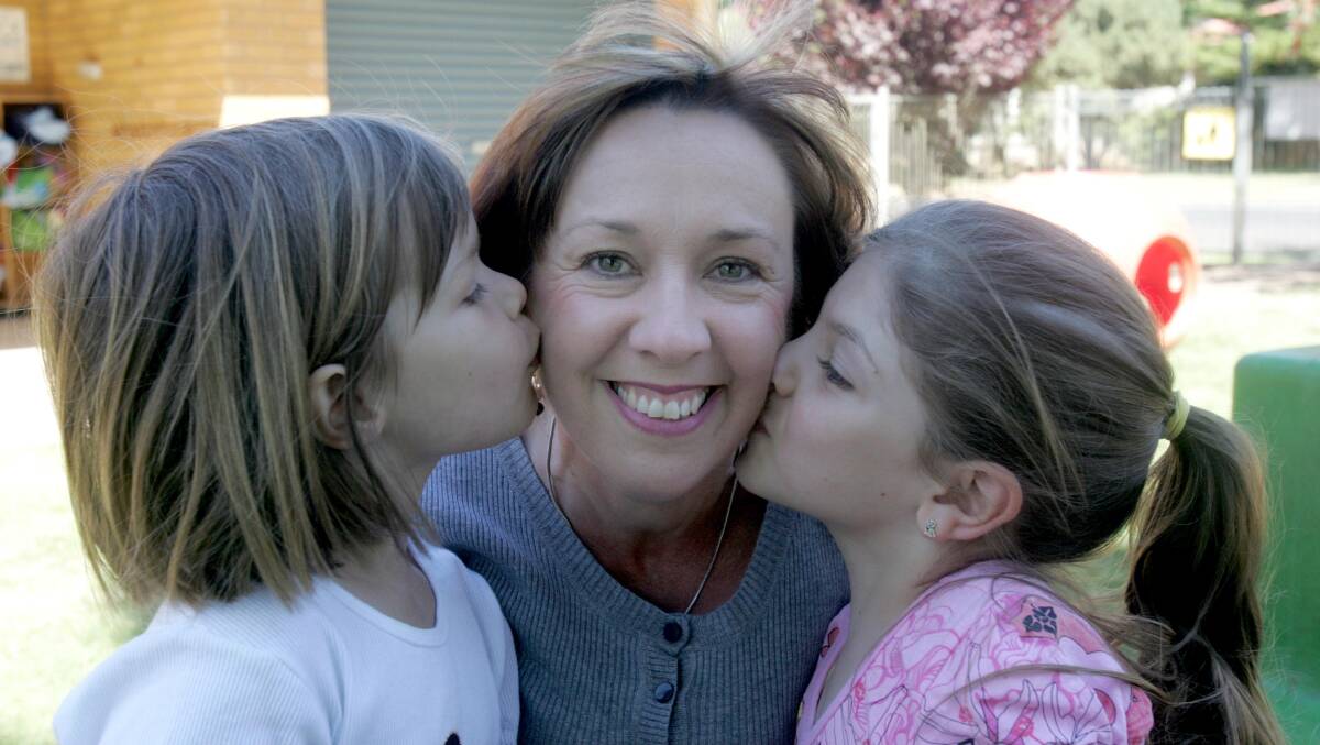 2008: Griffith East Preschool director Suzy Tucker celebrates her 20th year with the school. Preschoolers Annabelle Irvin, 5, and Amanda Rizzeri, 5, congratulate Suzy on her milestone.