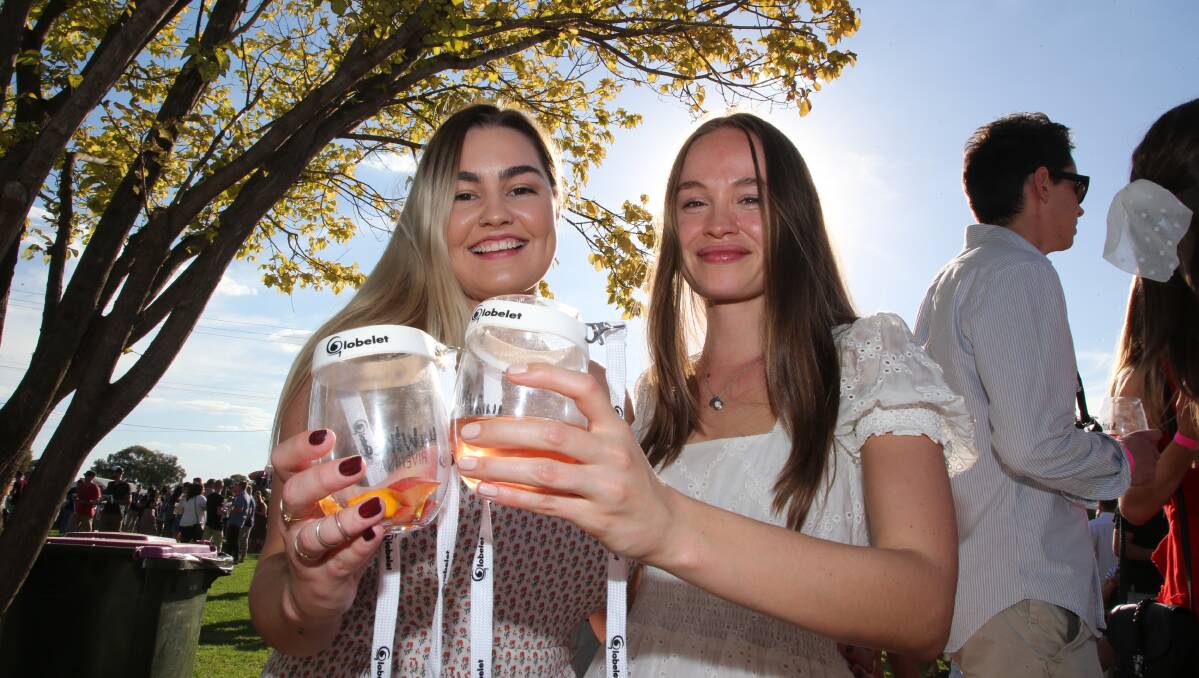 CHEERS: Ellen Pike and Lucy Folico enjoy a glass of locally produced wine at the 2019 Griffith Vintage Festival, which drew a crowd of over 2000 people. Picture: Anthony Stipo
