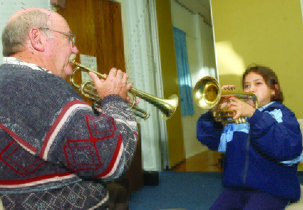 2004: Norm Hansford gives Geneiveve Sibbick her first trumpet lesson, thanks to a music outreach program by the Riverina Conservatorium. Picture: MICHAEL KELLY