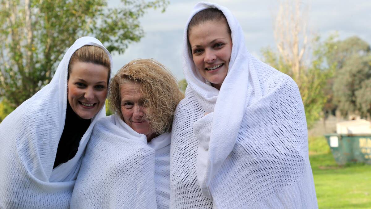 2014: Scalabrini Village staff members Tiffany Bodocco, Janine Wood and Gemma McNab were among those who braved the cold on Saturday night as part of the Mission Australia Winter Sleep Out. Picture: Anthony Stipo