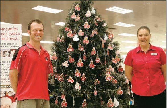 2008: Looking for kind Griffith shoppers to buy presents for those in need are the Uniting Church’s Rev Matthew Trounce and Target store manager Lisa Morrison.