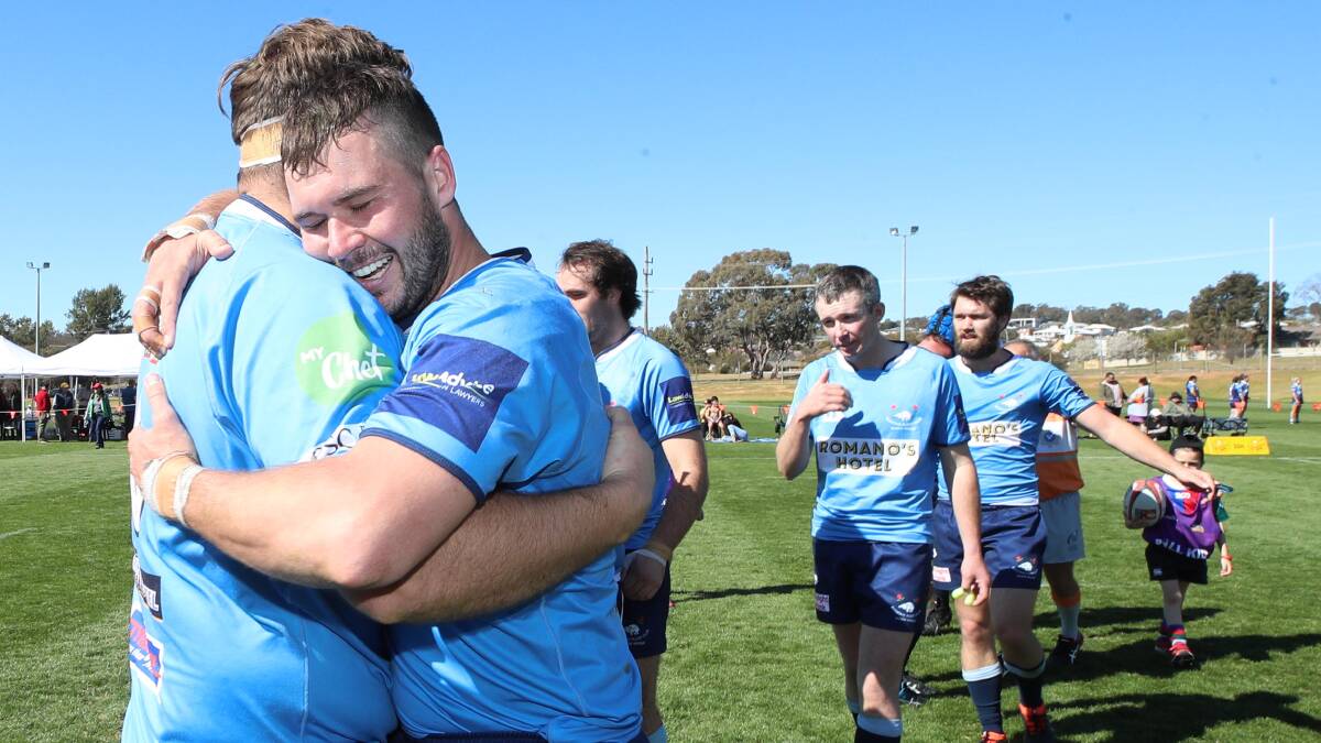 Waratahs players celebrate after winning the second grade grand final over Ag College.