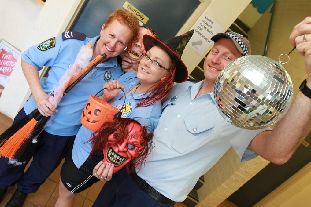 2013: Senior Constable Pete Naisby, Griffith  PCYC activity officer Amber Bland and Senior Constable Alex Davies get ready for the return of Griffith's Halloween themed Blue Light Disco. Picture: Anthony Stipo
