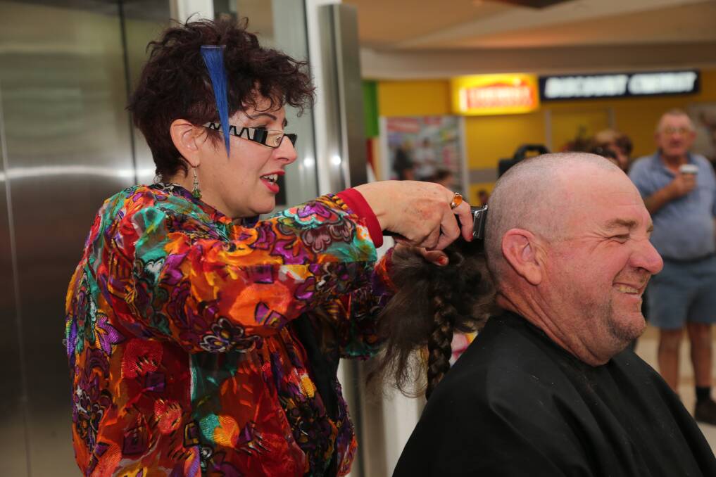 2014: Hairdresser Liz Martin uses her clippers to turn Brett Brown from tatty to tidy for a good cause.