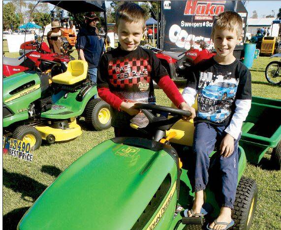 2009: Tim and Paul Pfitzner, aged 6 and 8, try out the ride-on lawnmowers at the Riverina Field Days on Saturday. Tim and Paul were just two of 10,000 people who flocked through the gates of the agricultural fair.