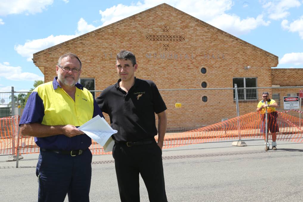 2014: David Alpen (left) and Matt Boudreau from Casella Wines checking plans to strengthen the facade of the Yenda Memorial Hall.