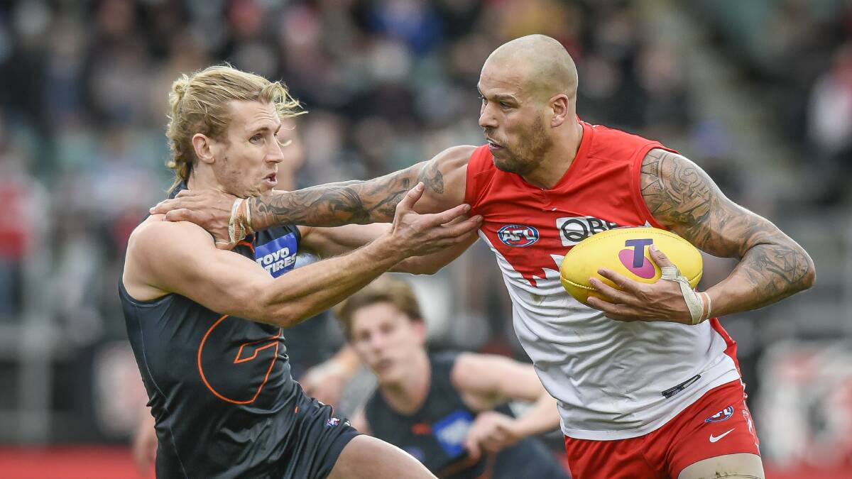 Lance Franklin removes GWS defender Nick Haynes from his path. Photo: Craig George, The Examiner 
