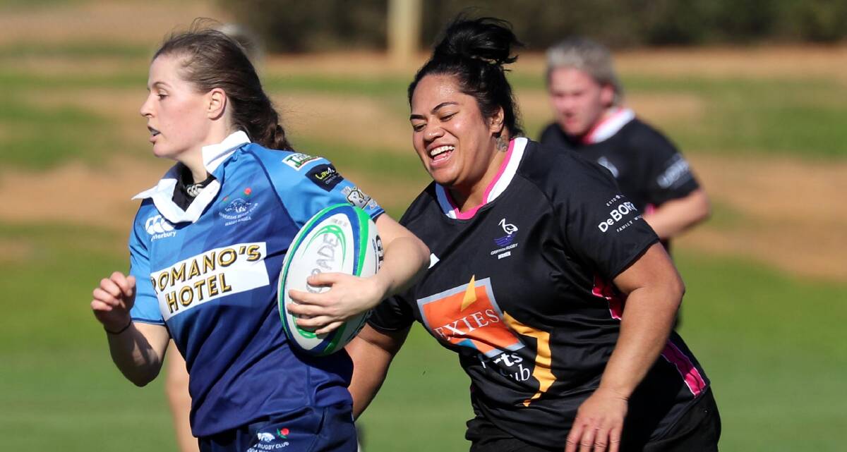 CAN'T CATCH ME: Andrea Kirkby runs past.Seigia Seukeni in Waratahs 44-10 win over Griffith at Conolly Rugby Complex on Saturday. Picture: Les Smith