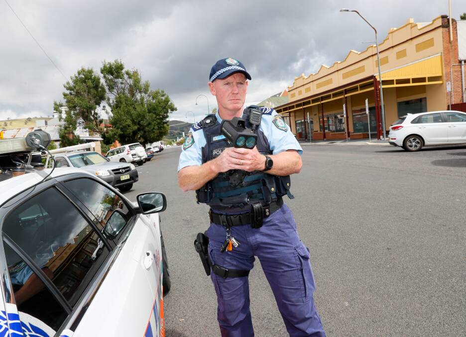 Riverina Highway Patrol officer senior constable Russell Culley with a radar speed camera in Gundagai. Picture by Les Smith 