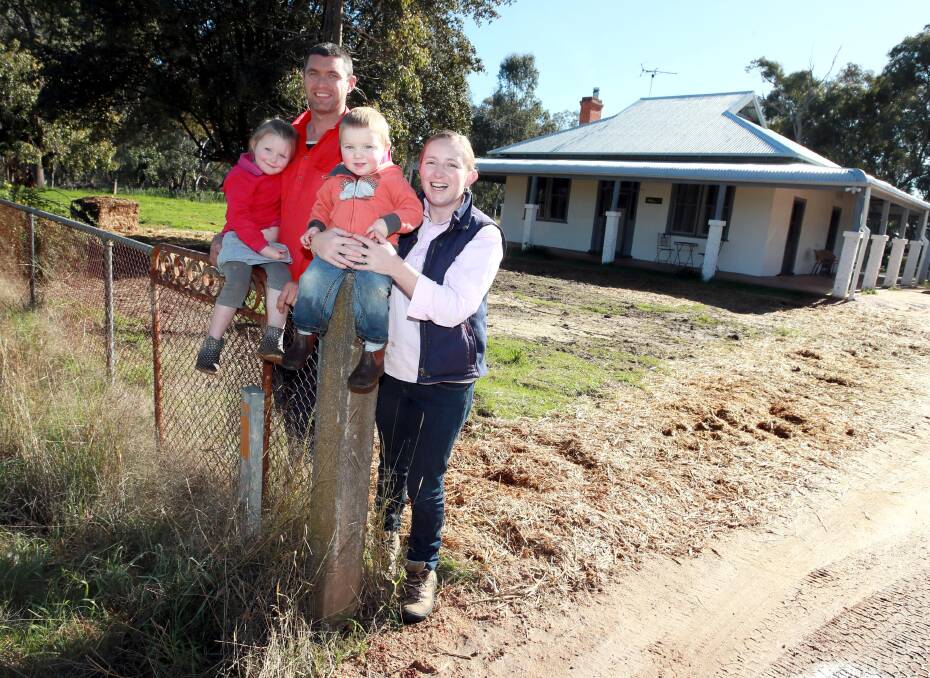  NEW LIFE: Joel and Emma Sim with two of their children, Annie, 4, and Jack, 1. Picture: Les Smith 