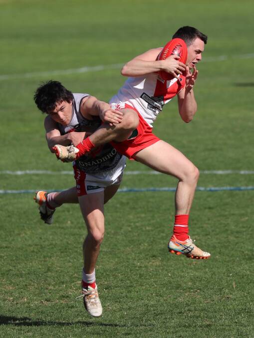 New Coleambaly signing Tom Valeri takes a mark over Dan Kennedy in the Swans' 2018 first grade finals campaign.