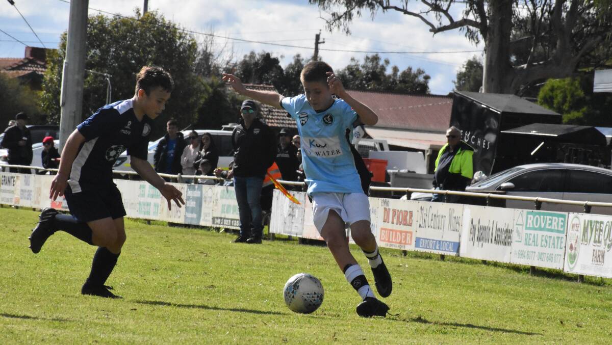 STEP INSIDE: Griffith FC's Kobe Ellis looks to get around the Belconnen United defence during the under 14s clash. PHOTO: Liam Warren