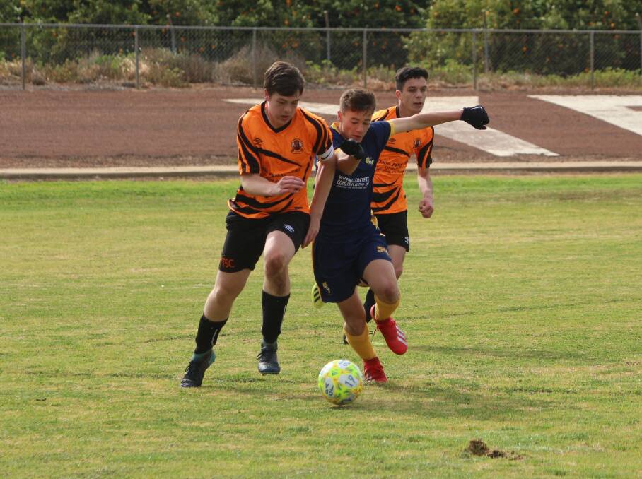 JOSTLING FOR POSITION: Yenda Tigers' Mason Patten and Yoogali SC's Ethan Andreazza fight for possession during last season's under 16s grand final. PHOTO: Calhan Behrendt