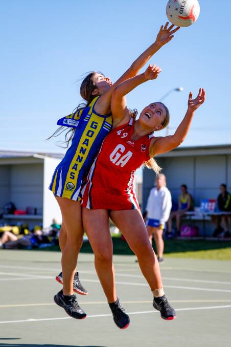 PHYSICAL BATTLE: MCUE goal defender and captain Shannan Russell and Griffith goal attack Jenna Richards grapple for the ball during their Riverina League netball clash on Saturday. Picture: Andrew McLean Photography
