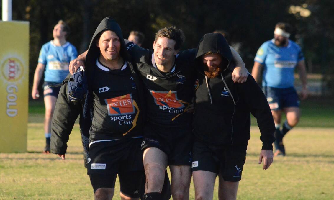 Blacks' Daniel Bozic is helped from the field last weekend by Kieran McNabb and Jason Waring-Bryant. Bozic will miss this weekend and is in doubt for the clash with CSU as well.