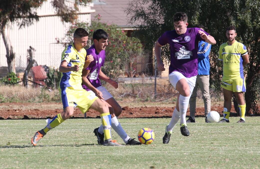 FIGHTING FOR POSSESSION: Yoogali FC's Roy Catanzariti looks to keep control of the ball in his side's game against Glebe. PHOTO: Anthony Stipo