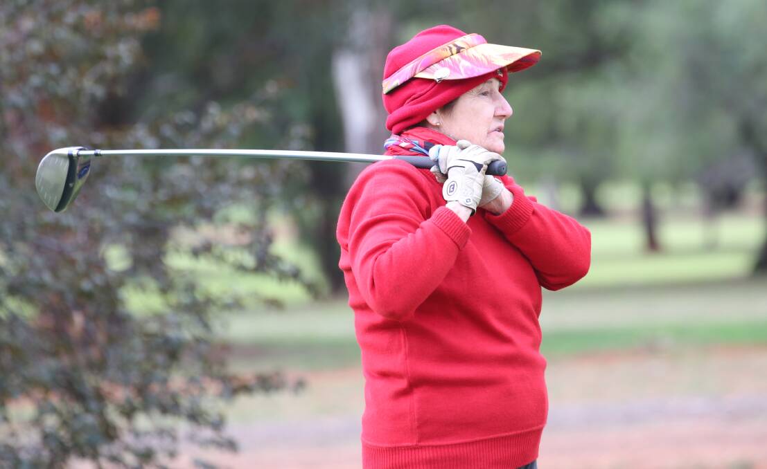 WATCHING IT FLY: Kath Gullifer keeps her eye on the ball after teeing off at the Griffith Golf Club. PHOTO: Anthony Stipo