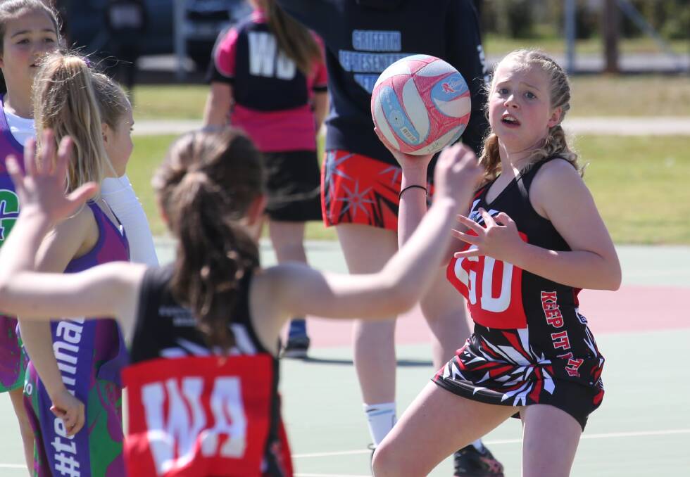 LONG PASS: Keep It North's Annie Jones looks to play the ball to a teammate during their finals match against #teamnato. Picture: Anthony Stipo
