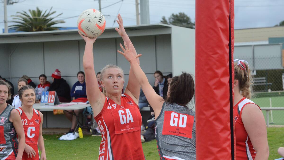 LINING UP: Swans' Jenna Richards takes a shot against the Demons.