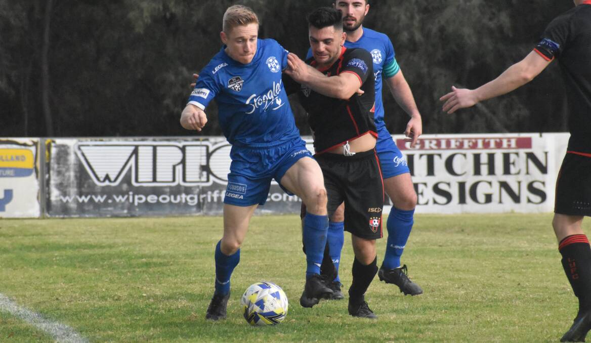 BATTLE ON: Hanwood's Andy Gamble looks to keep possession during his side's match against Leeton before it was abandoned. PHOTO: Liam Warren