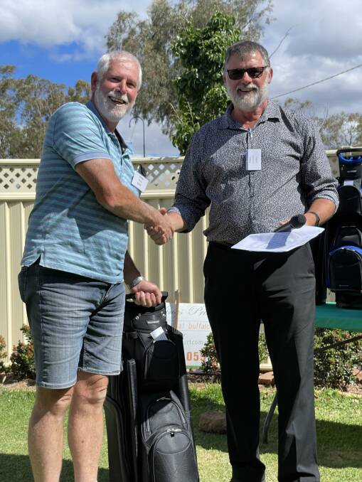 ALL SMILES: Director Rob Trembath presenting the trophy to Men's A grade winner Graham Sibraa from Griffith. PHOTO: Contributed